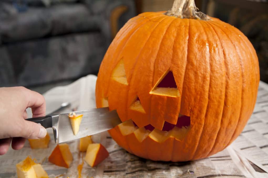 Carving a face into a pumpkin