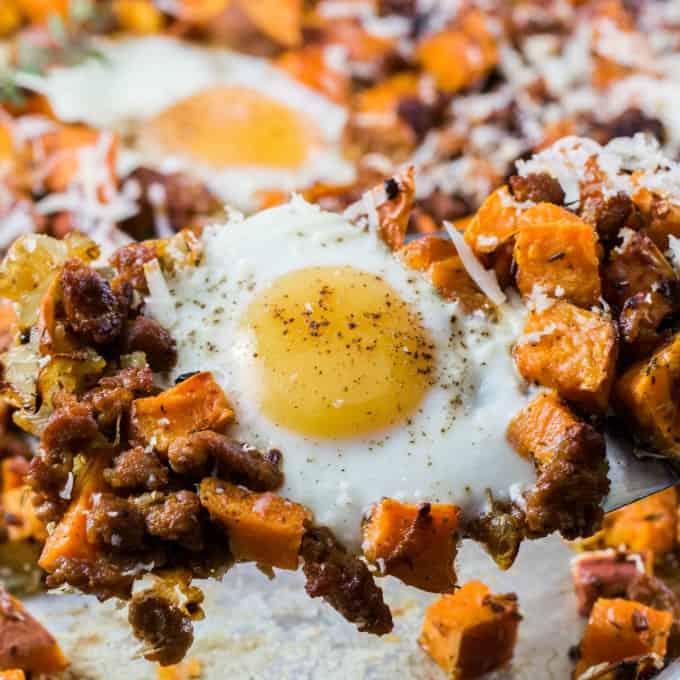 Beautiful egg with sweet potatoes and sausage on a spatula