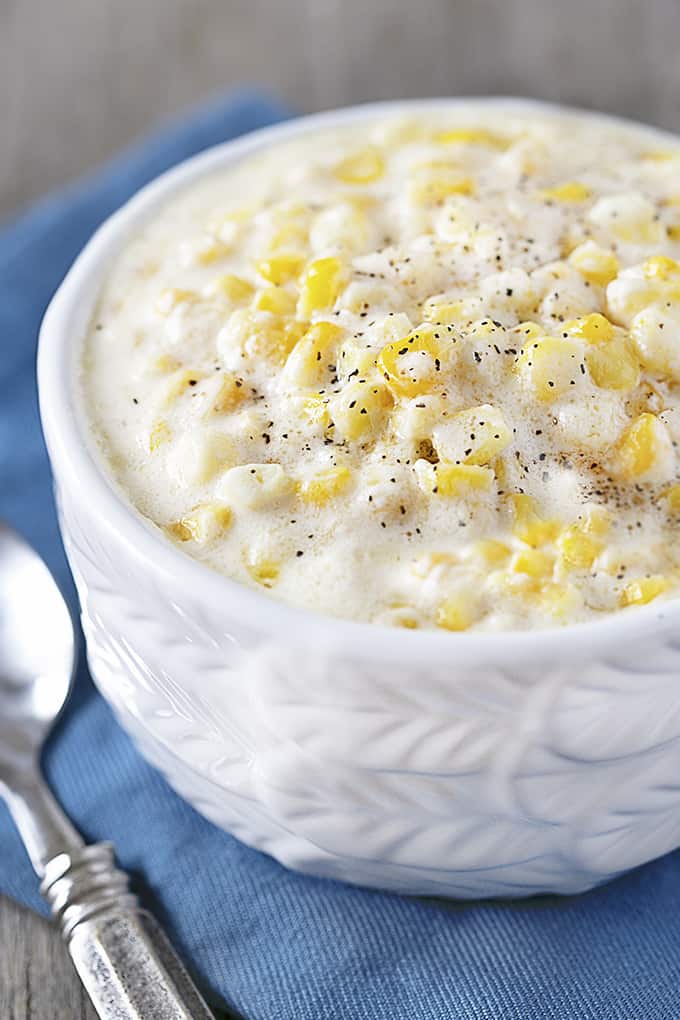 Bowl of Slow Cooker Creamed Corn garnished with pepper.