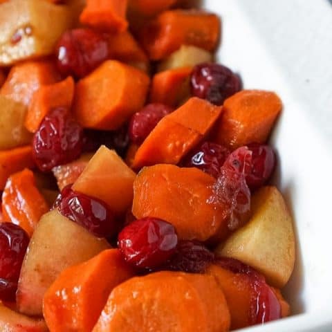 slow cooker carrots in a white serving dish