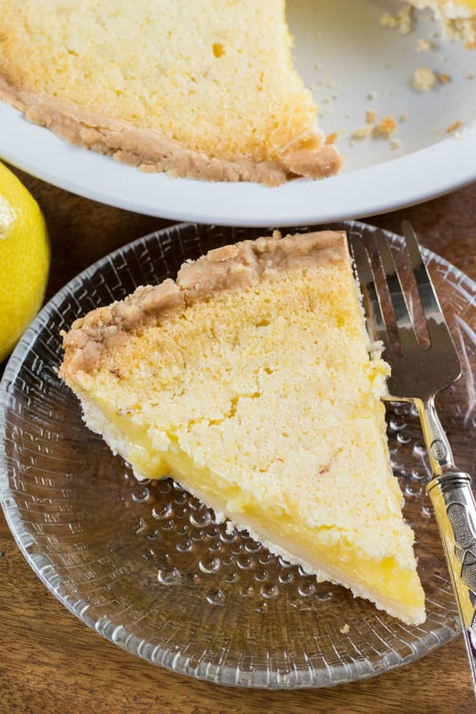 Overhead view of a slice of pie on a glass dish with a fork