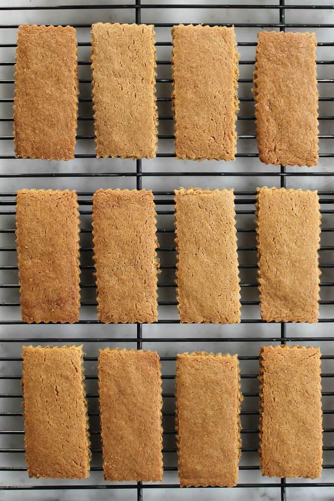 A black backing rack holds twelve brown rectangular cookies in neat rows.