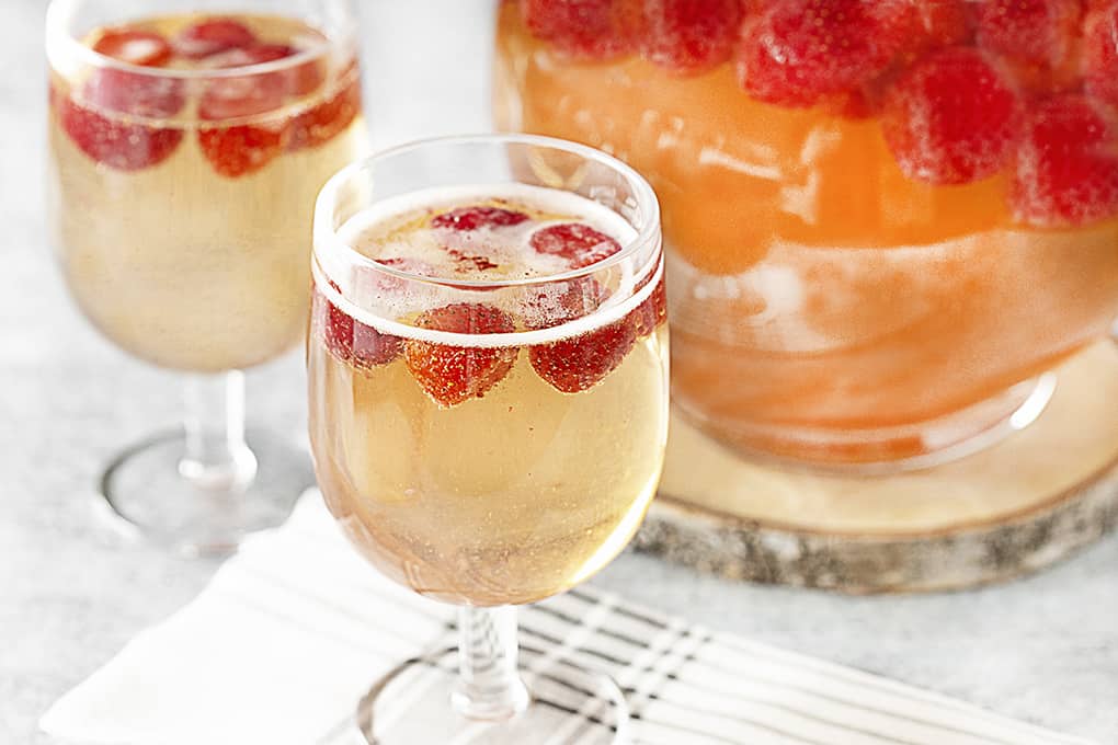 Strawberry Champagne Party Punch in glasses and a pitcher