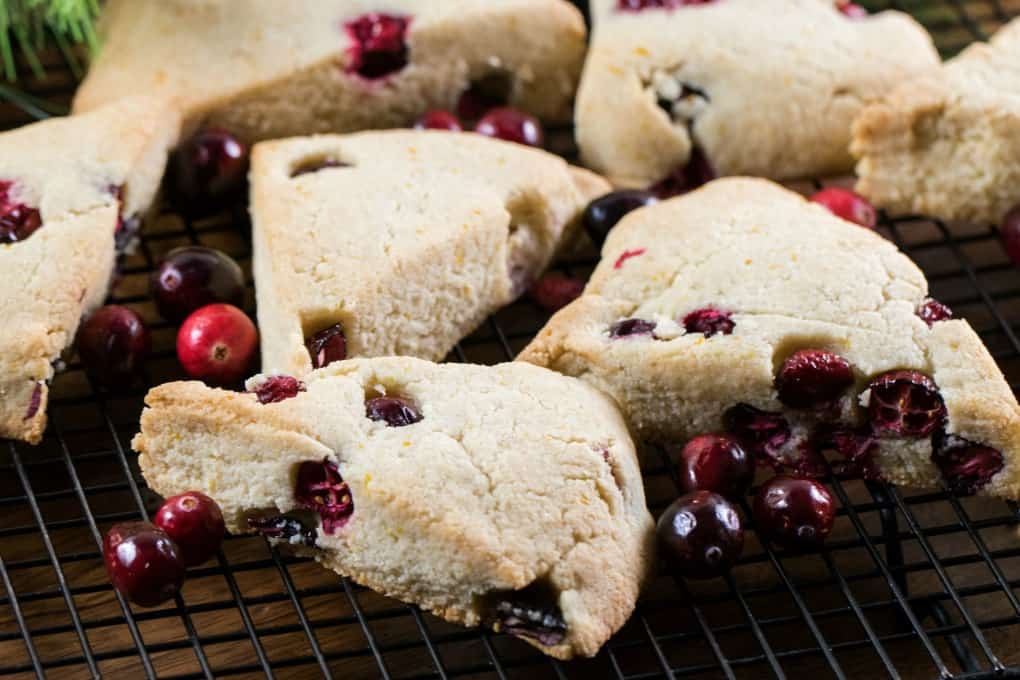 Cranberry Orange Scones on a wire rack with fresh cranberries