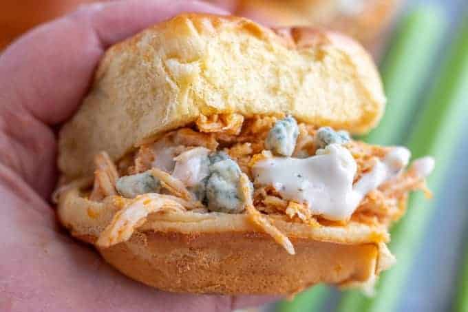 buffalo chicken sliders close up in a hand