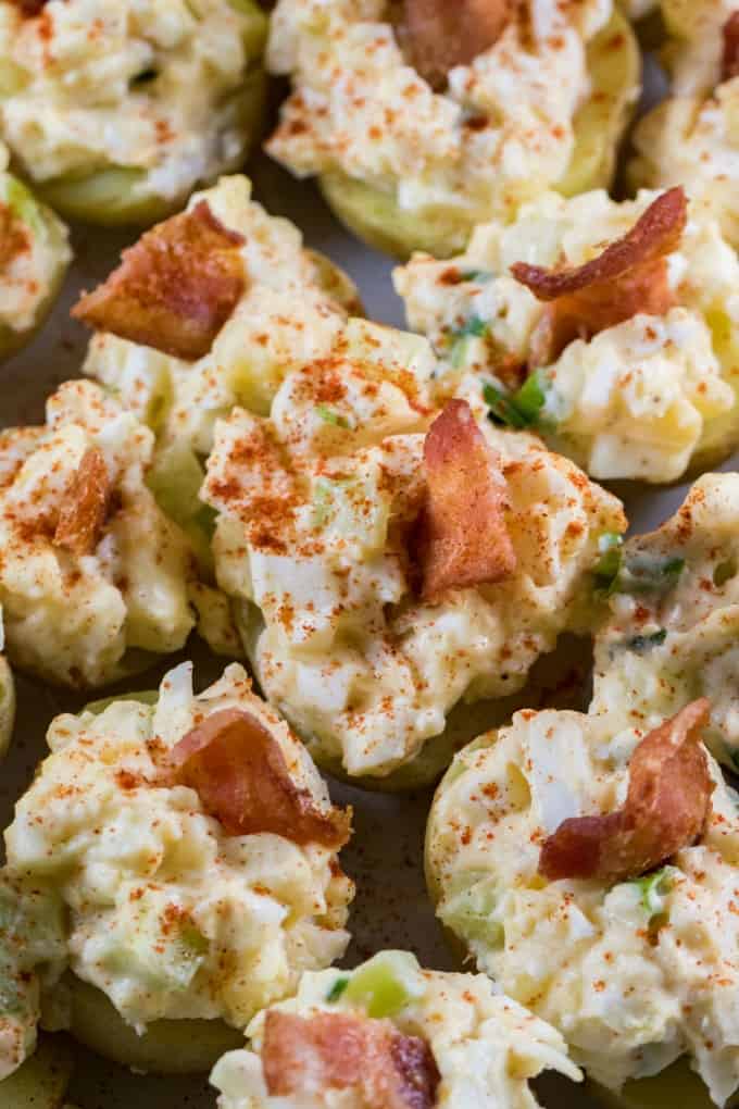 Close up of stuffed potatoes with egg salad and bacon