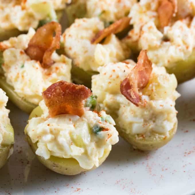 Close up of stuffed potatoes with egg salad and bacon