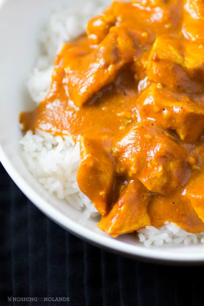 A close up of Healthy Slow Cooker Butter Chicken over rice in a bowl