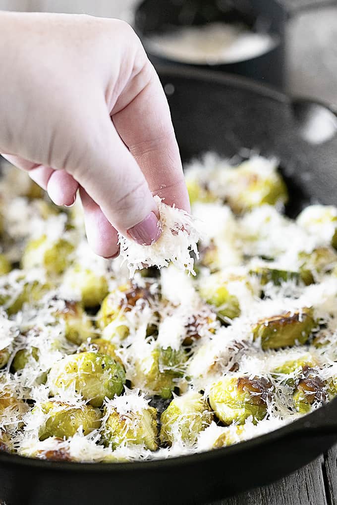 Sprinkling Parmesan on Roasted Brussels Sprouts