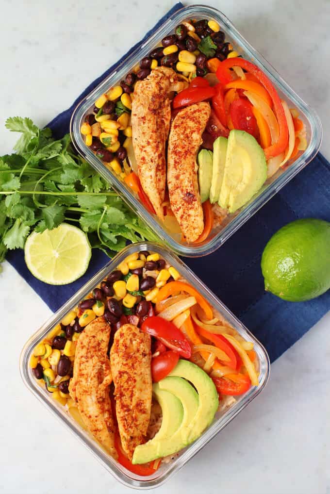 Healthy Chicken Burrito Bowl - overhead photo featuring two glass containers filled with healthy vegetables, bean salad, avocado, rice, and chicken tenders. 