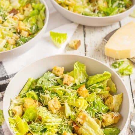 Bowls of Caesar Salad with Parmesan cheese.