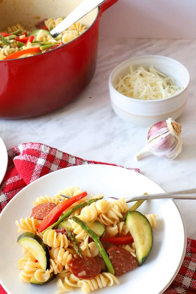 Easy Chorizo Pasta on a plate with a pot in the background