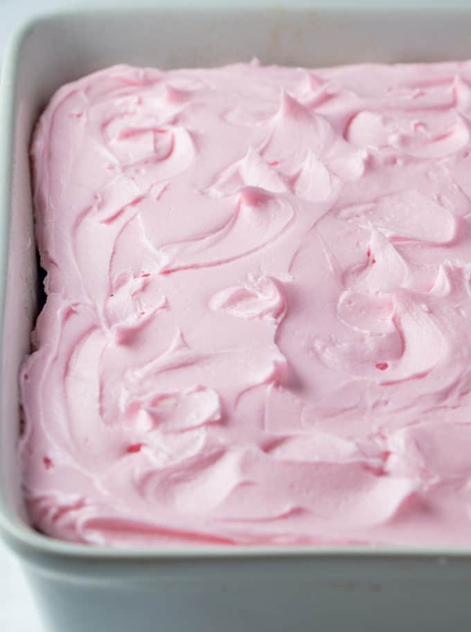 Frosted pink lemonade cake in a pan