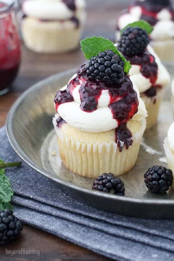 Blackberry bourbon smash cupcakes on a silver tray