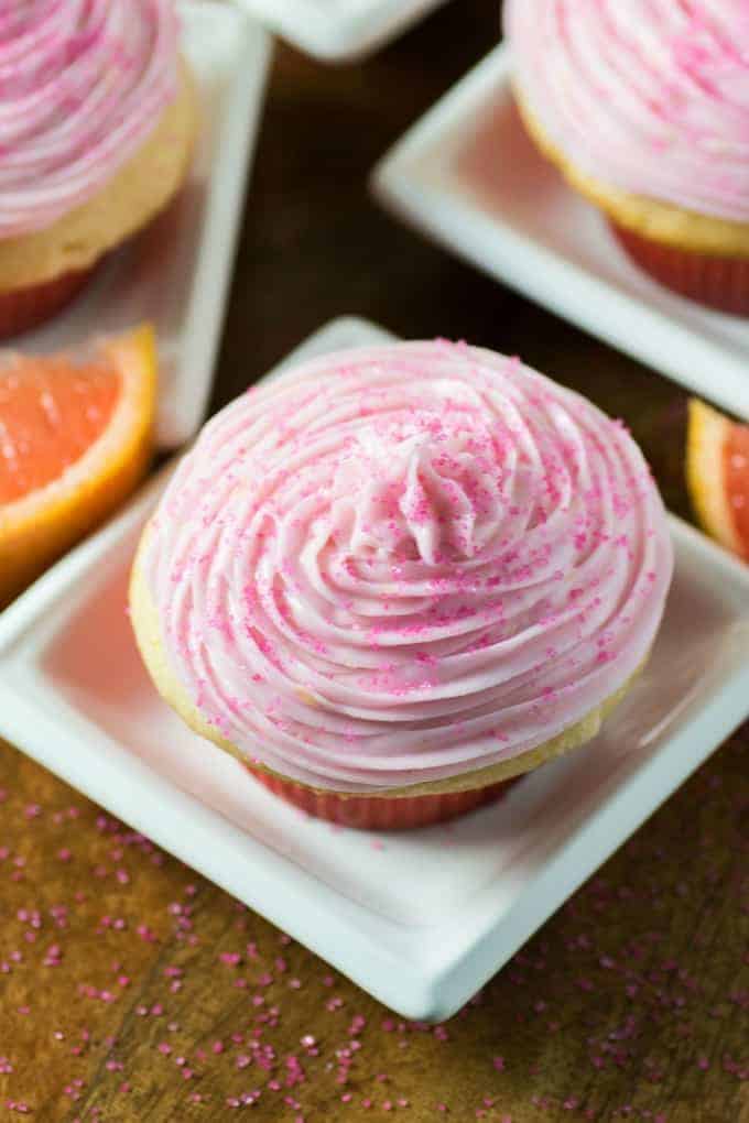 Grapefruit cupcakes on small white serving plates