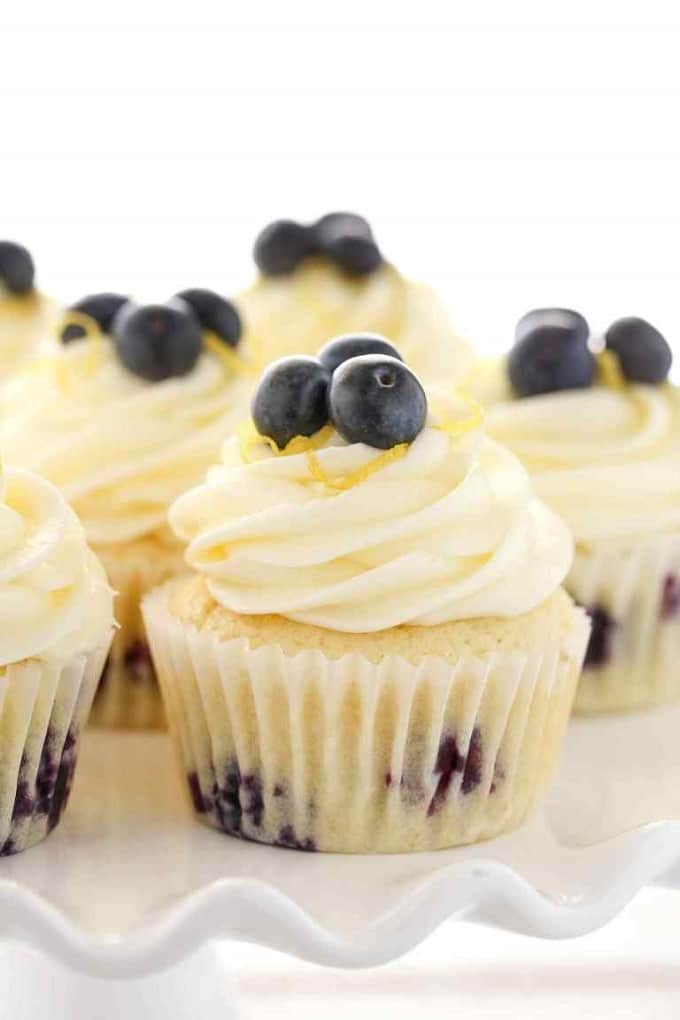 Lemon Blueberry cupcakes with lemon cream cheese frosting on a white plate
