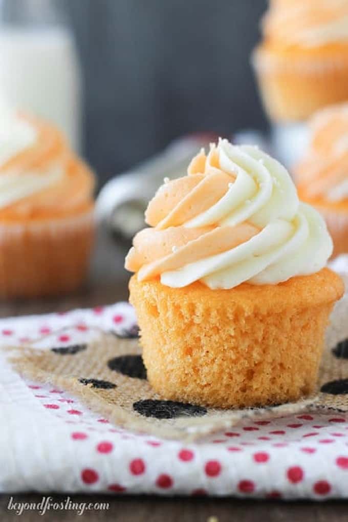 Orange cream pop cupcakes on a polka dot towel