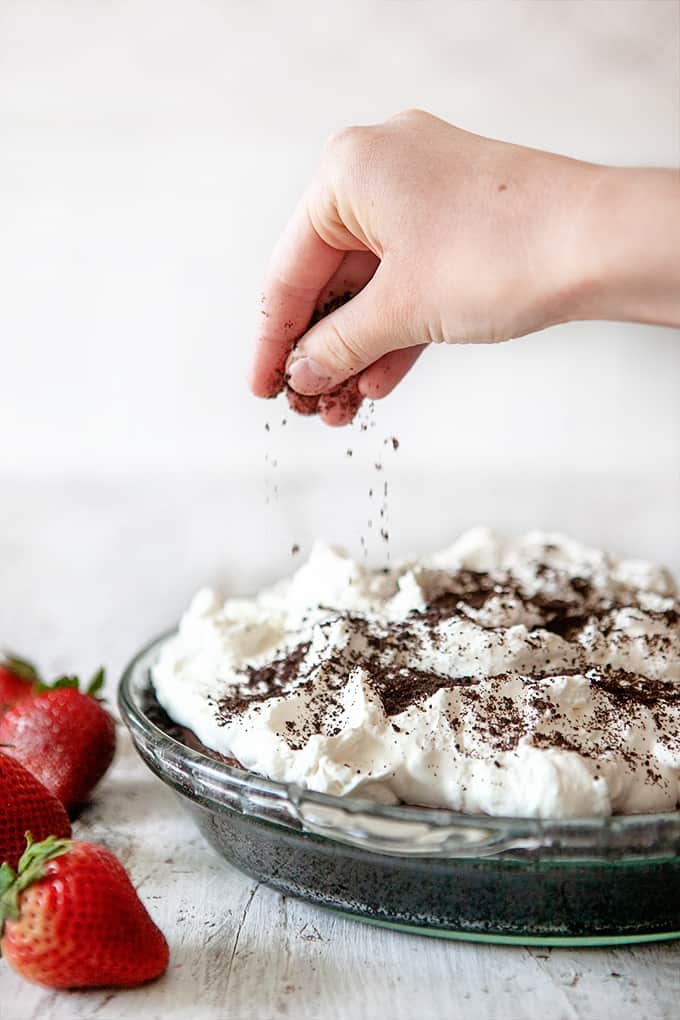 Sprinkling Cookie Crumbs on a Chocolate Pudding Pie