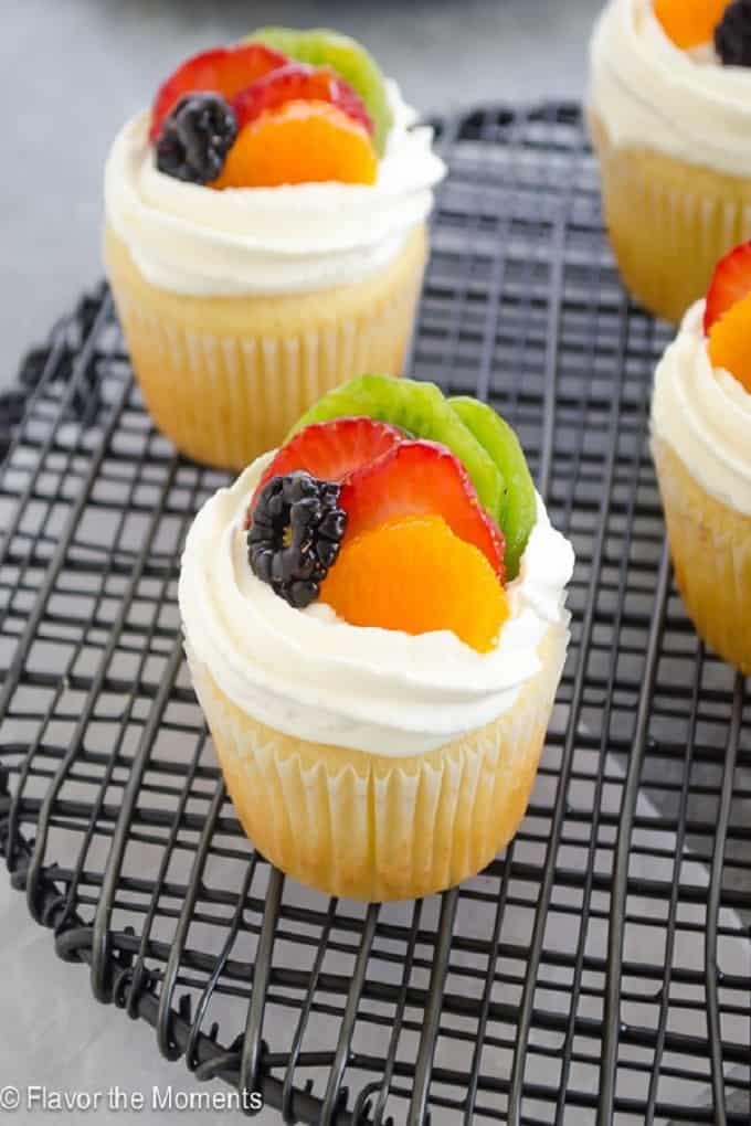 Fruit tart vanilla cupcakes on a wire cooling rack
