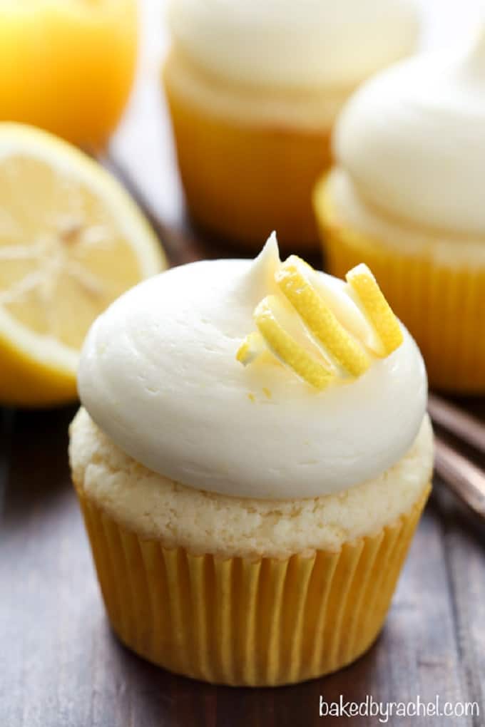 Lemon cupcakes with lemon cream cheese frosting on a wooden board