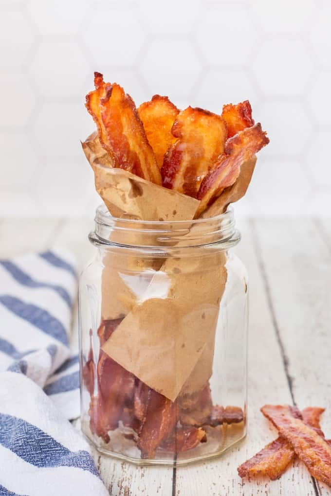Brown Sugar Bacon wrapped in brown paper in a jar