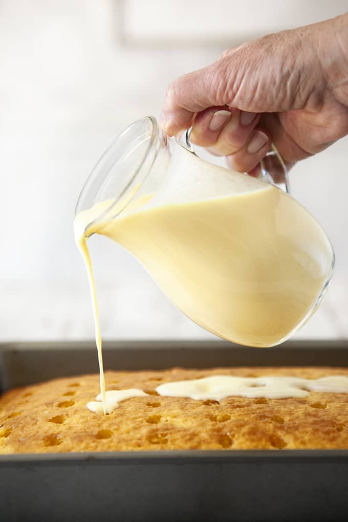 Pouring pudding into a Boston Cream Poke Cake