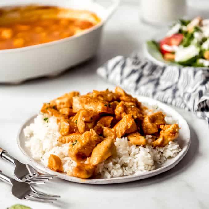 Russian chicken over rice on a white plate.