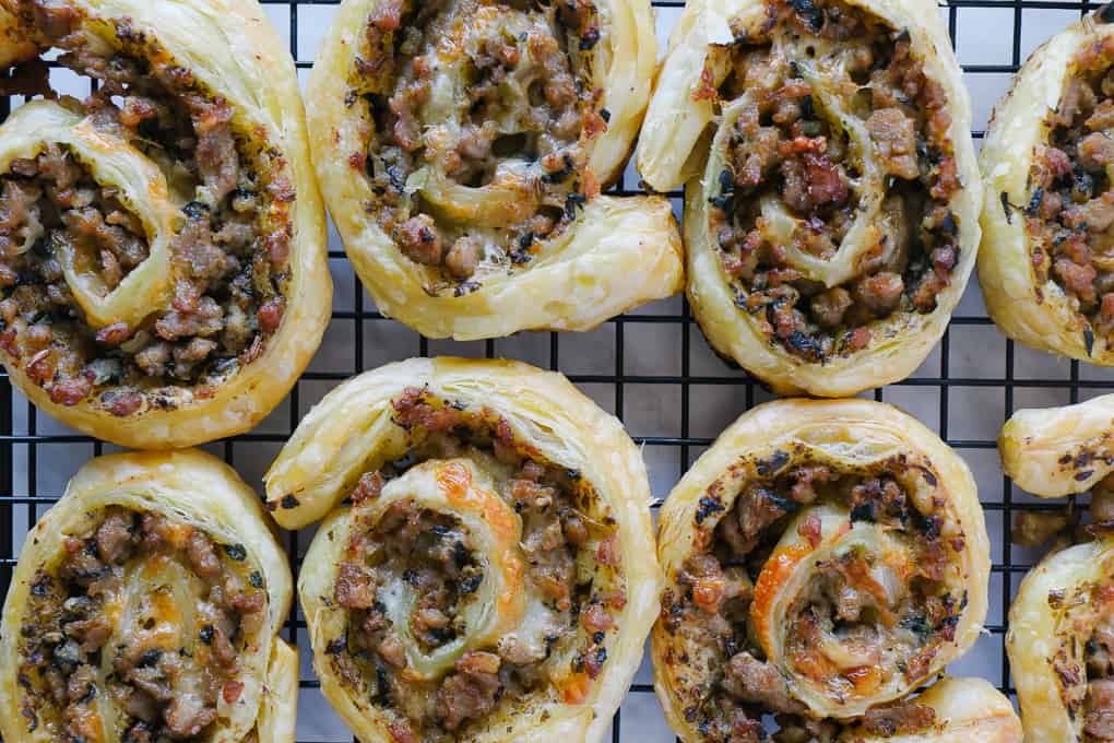 top view of close up of sausage pinwheels on a rack.