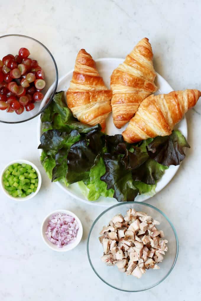 An arrangement of ingredients used in chicken salad with grapes.