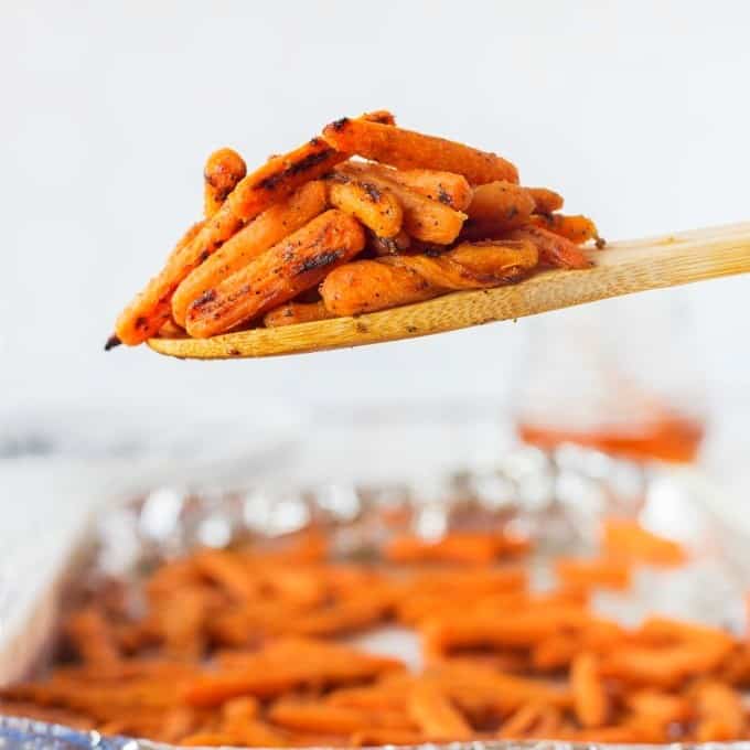A wooden spoonful of roasted carrots