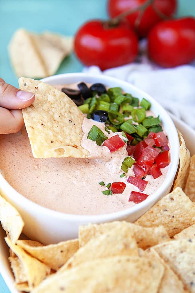 Closeup of a scoop of Mexicali dip on a tortilla chip