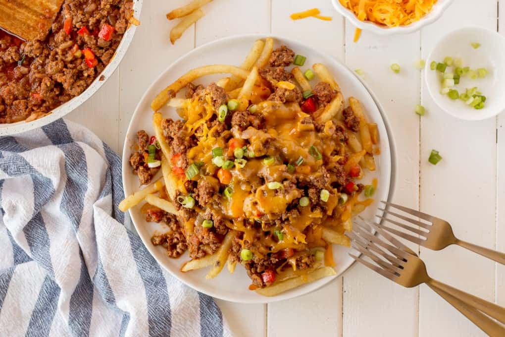 Chili Cheese Fries on a plate with forks