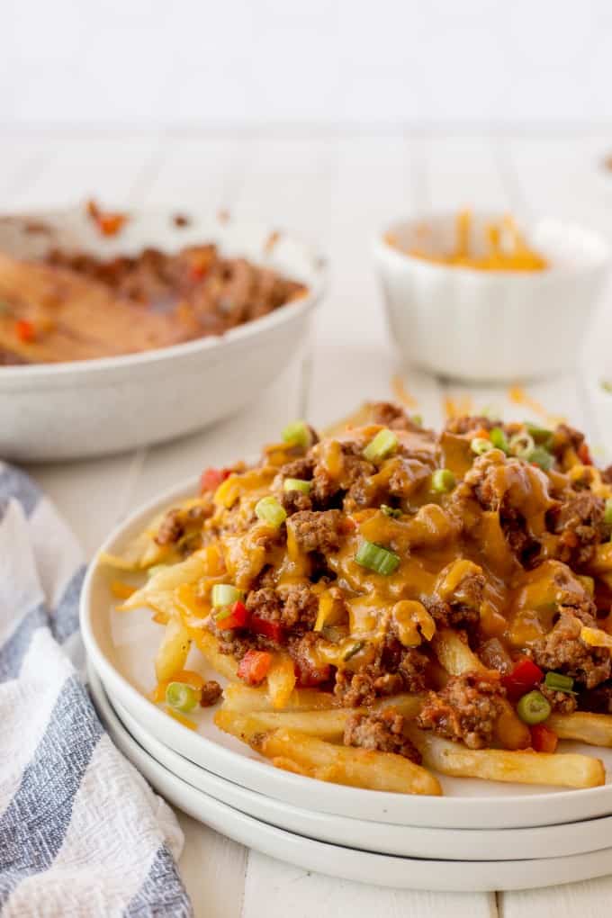 Chili Cheese Fries on white plates