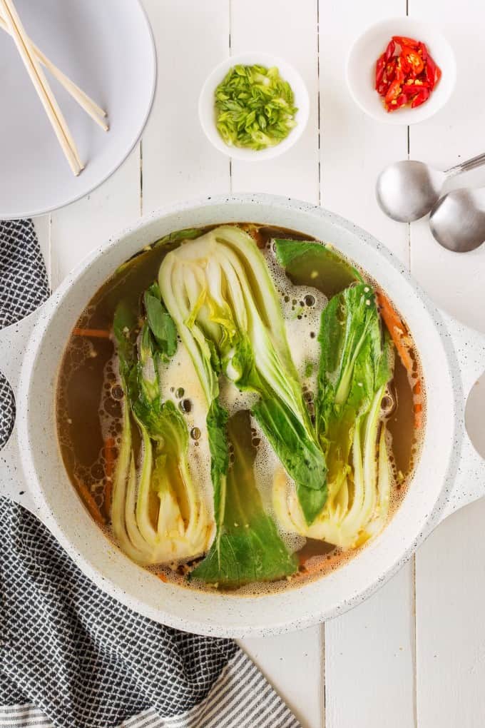 Simmering bok choy in a pot