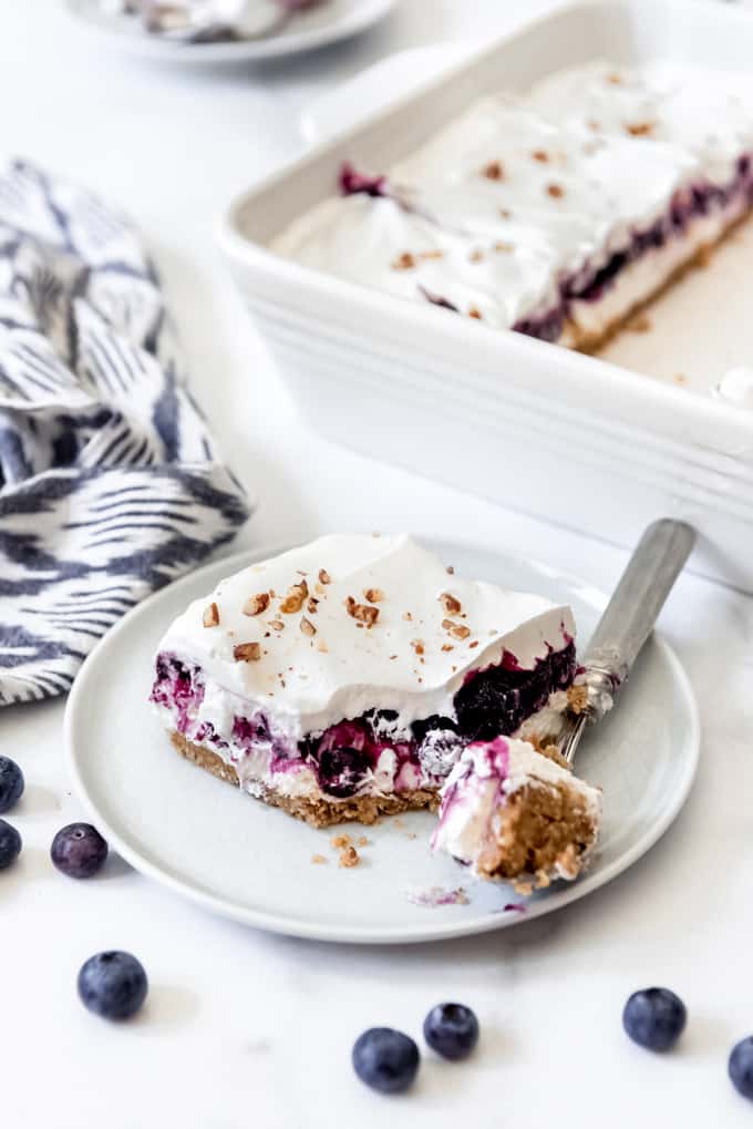 Blueberry delight - an image of a slice of blueberry delight on a plate with a fork.