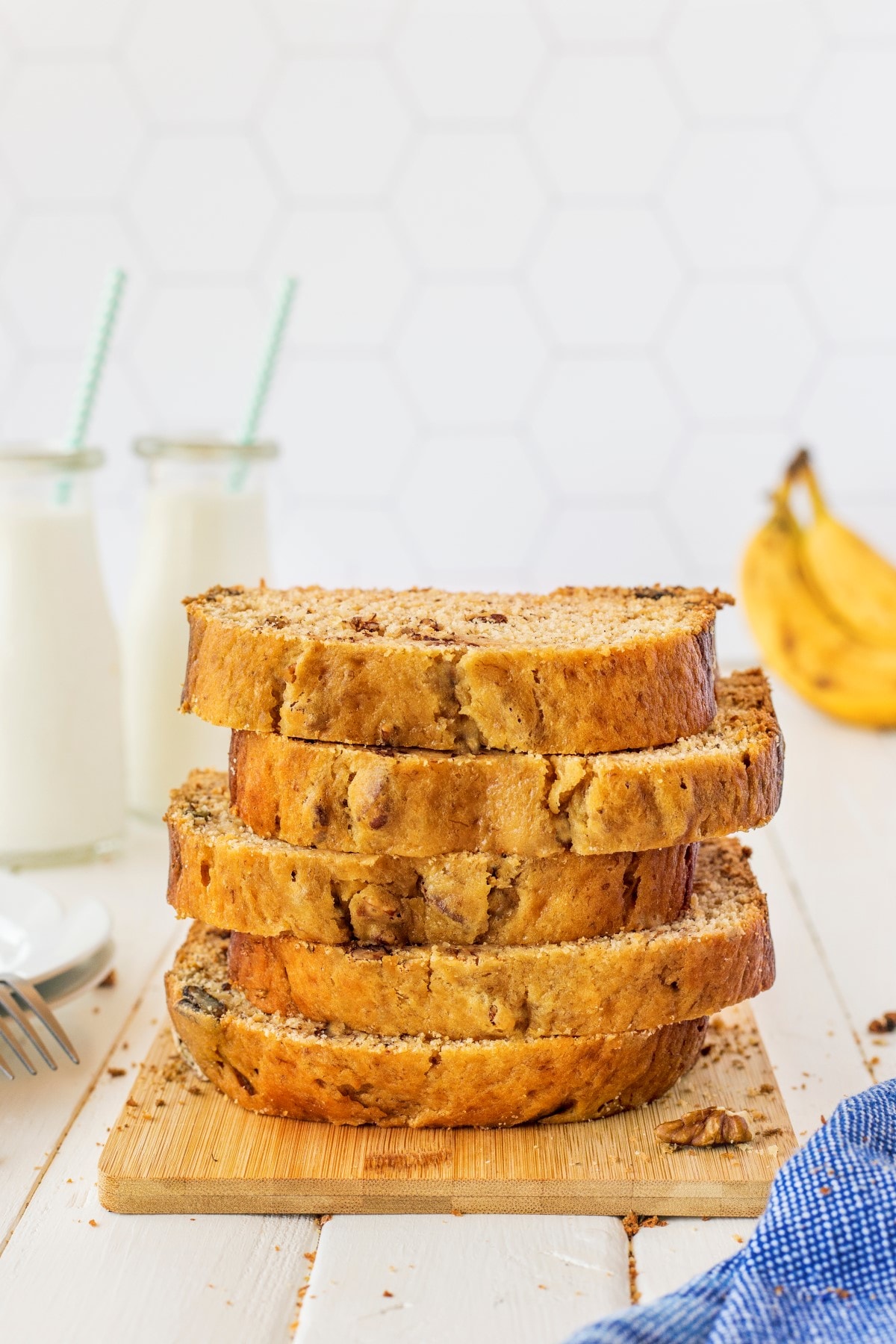 Bread Machine Banana Bread stacked on a wooden bread board.