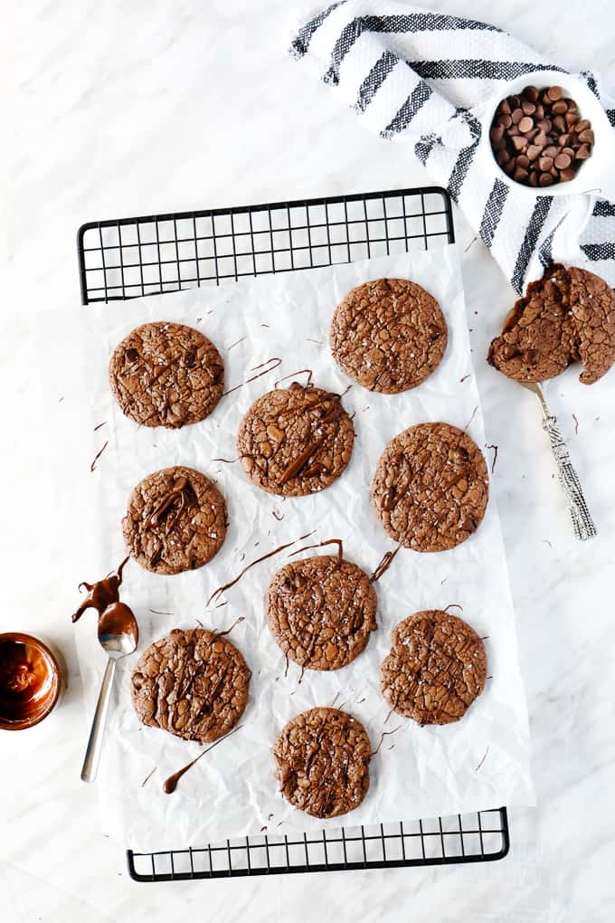 Brownie cookies on parchment paper on a cooling rack. 