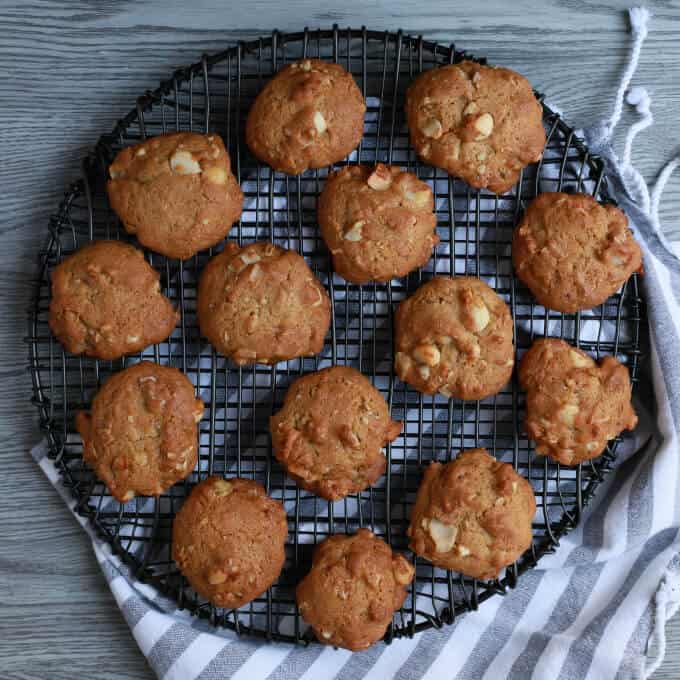 Baked cookies on a round black baking rack.