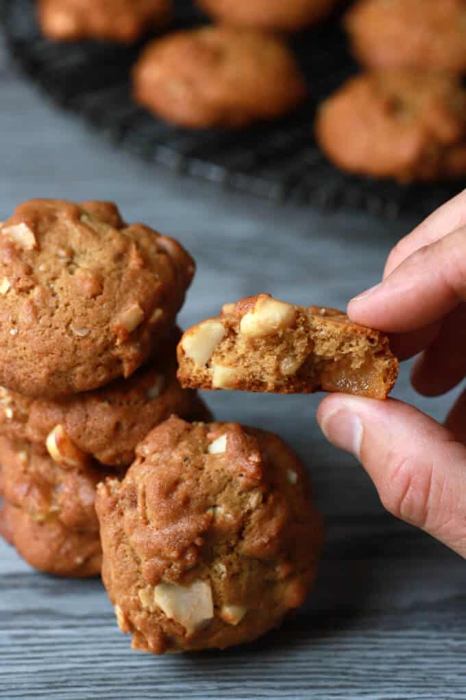 A hand holds a partially eaten cookie.