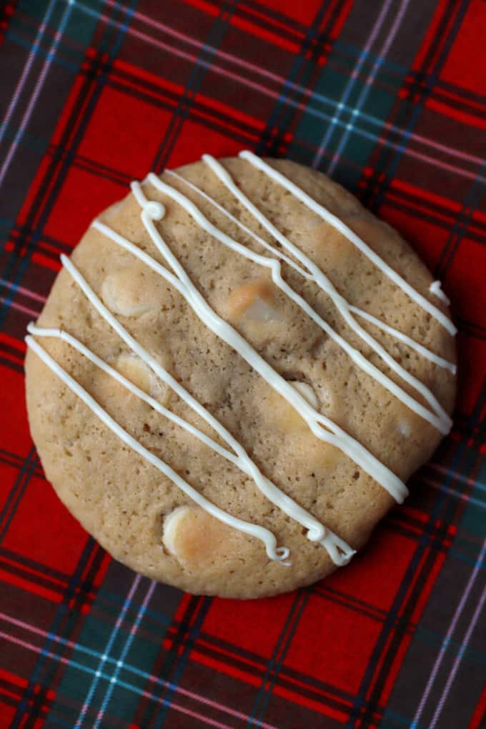 A close up of a golden baked chunky cookie on a plaid plate.
