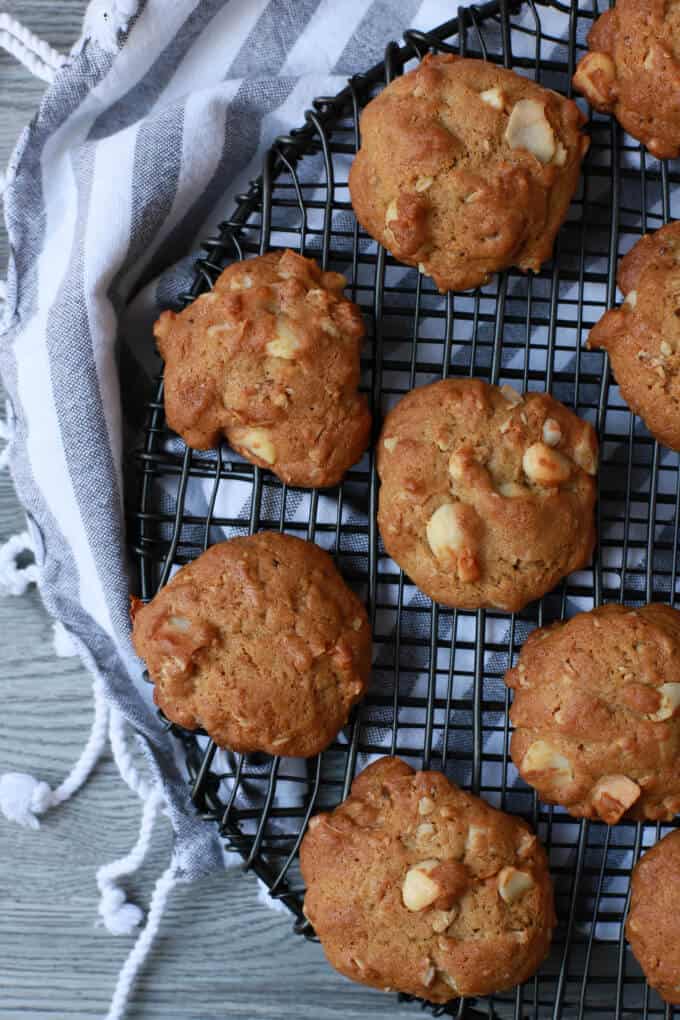 Baked tropical coconut granola cookies on a round black baking rack.