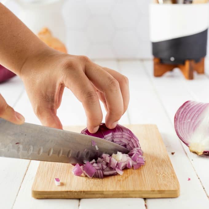 Dicing an onion with a sharp kitchen knife