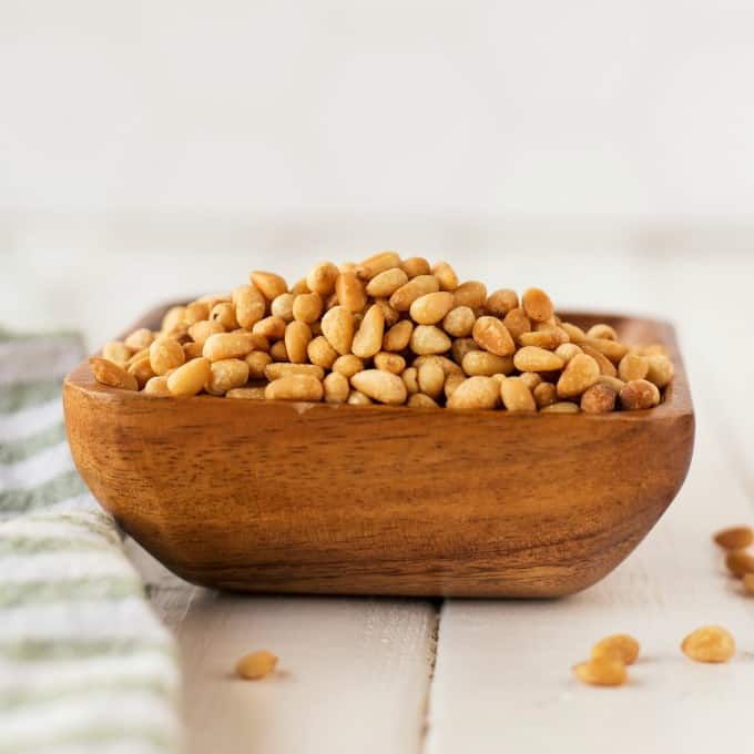 Toasted pine nuts in a wooden bowl. 