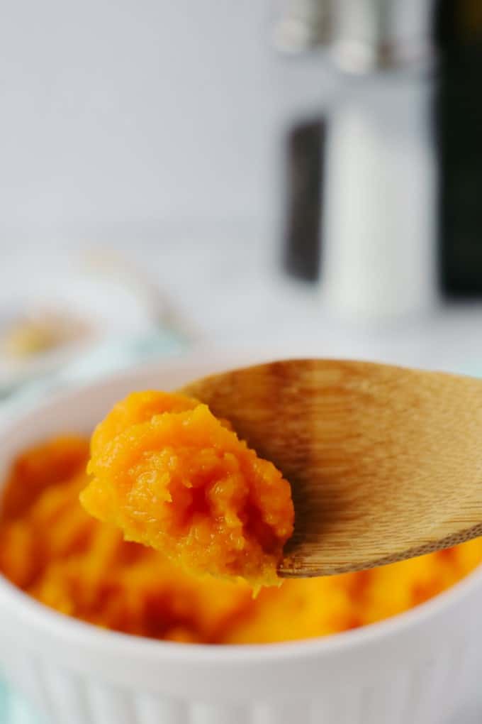 Mashed squash on a wooden spoon