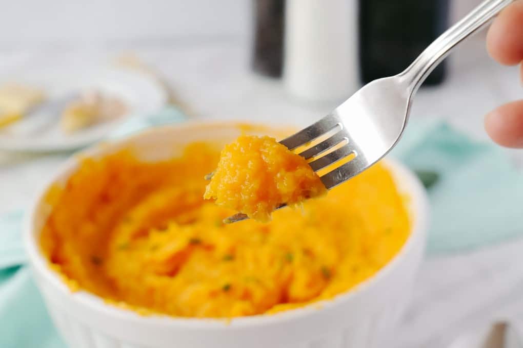 Showing mashed squash on a fork