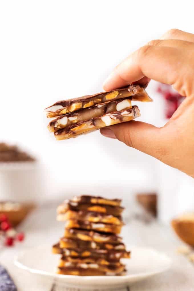 Holding up three pieces of Copycat Almond Roca