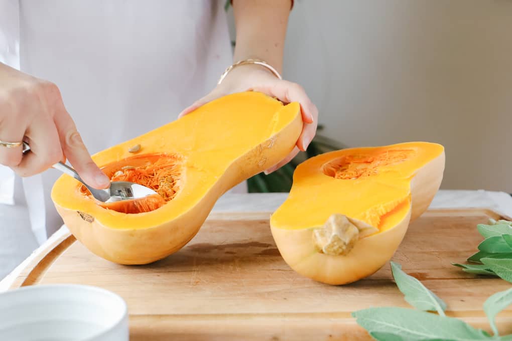 Scooping out seeds from squash