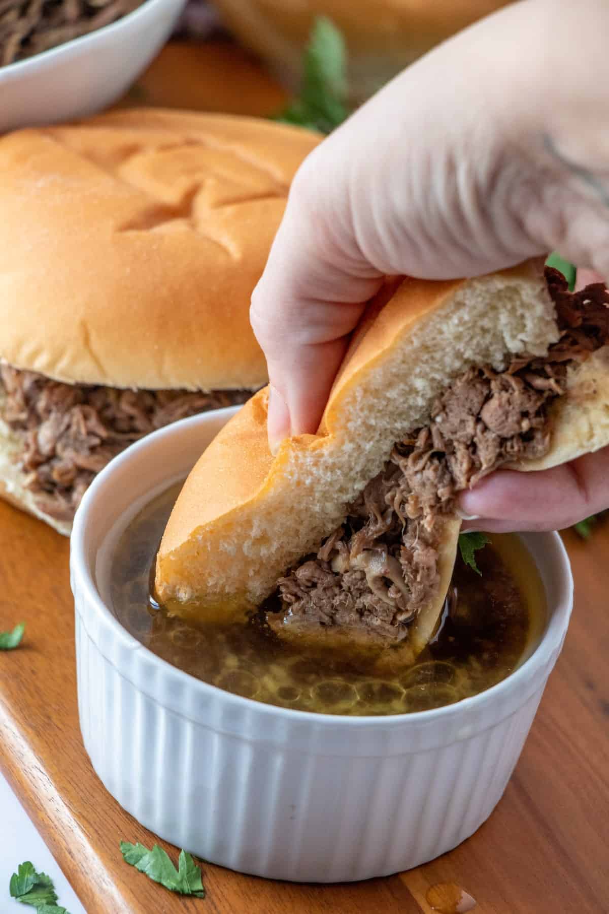 Dunking a beef dip sandwich in au jus