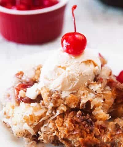 Cherry Pineapple Dump Cake with a cherry on top