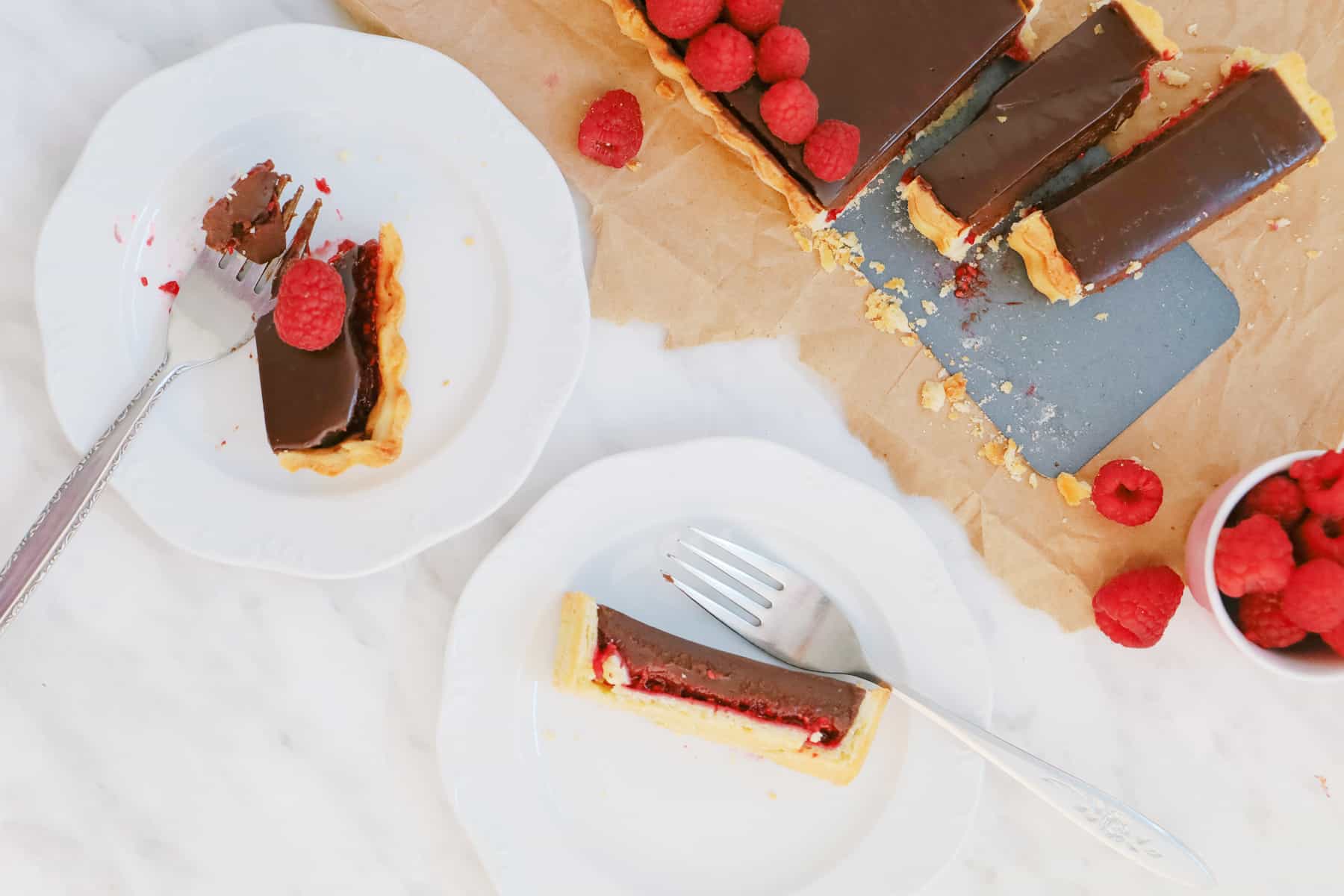 Overhead shot of serving a chocolate tart on plates